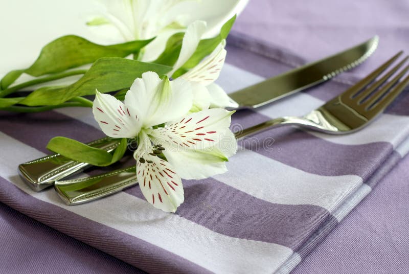 Plate, knife, fork and flowers.