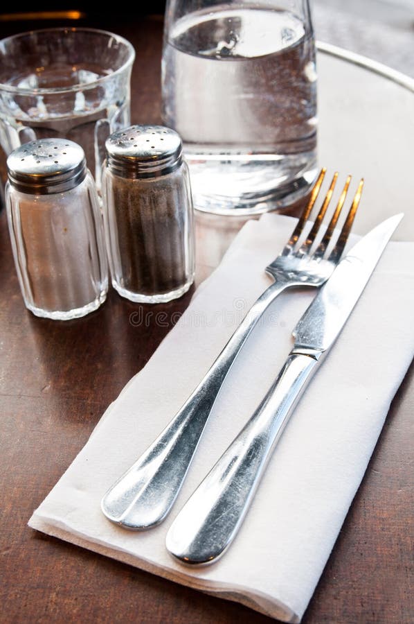 Place setting - plate, knife and fork on table