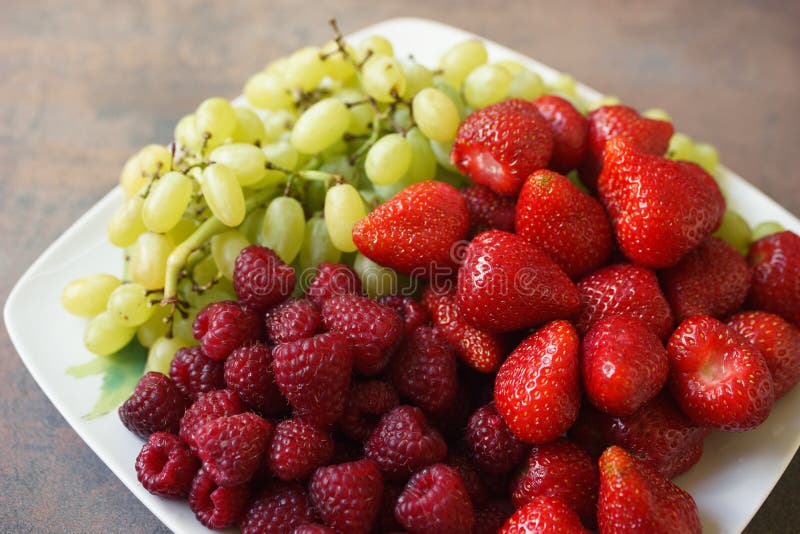 Plate Of Fresh Strawberries, Grapes And Raspberries Stock Image Image