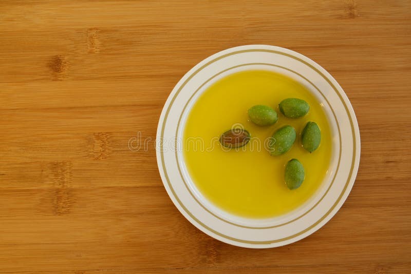 New Olive Harvest. Leaves and Berries of an Olive Tree on the Table