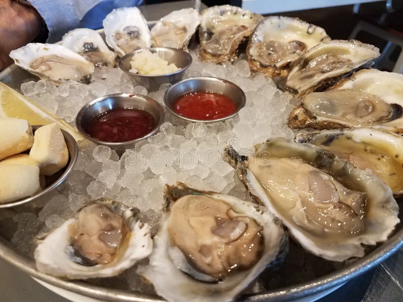 Plate of Oysters on Ice with Dipping Sauces Stock Photo Image of