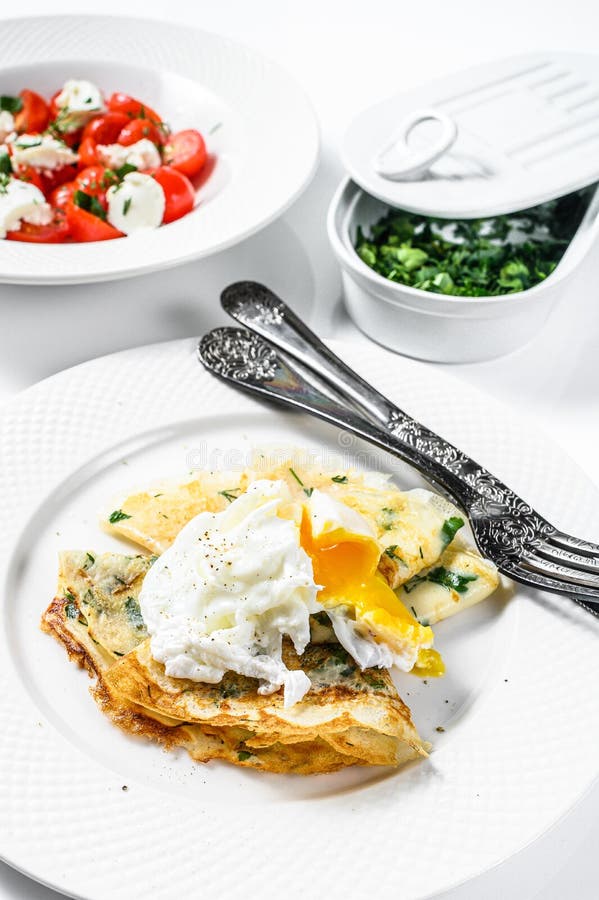 Plate of Pancake Stuffed with Spinach and Eggs. Caprese Salad with