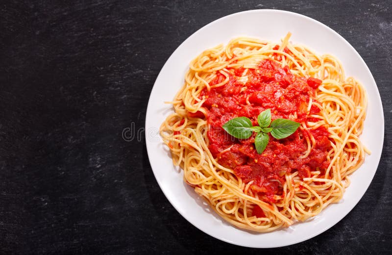 Plate of Pasta with Tomato Sauce on White Background, Top View Stock