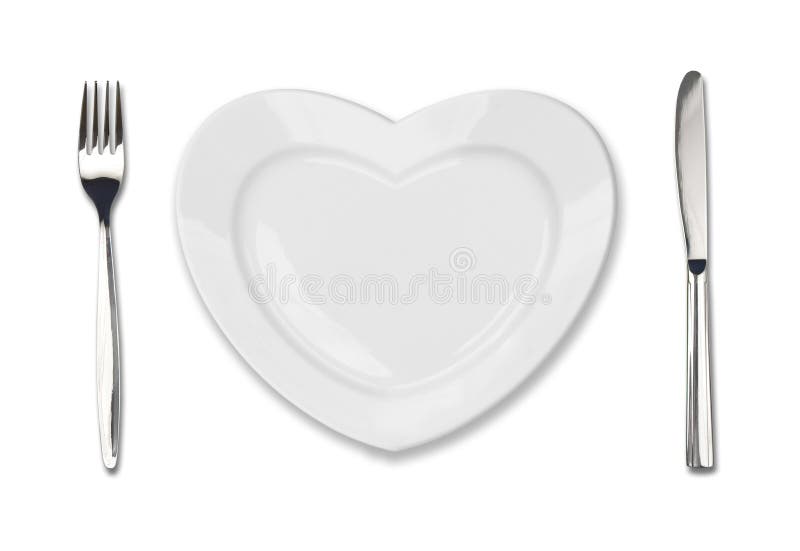 Plate in shape of heart, table knife and fork stock images Plate in shape of heart, table knife and fork stock images