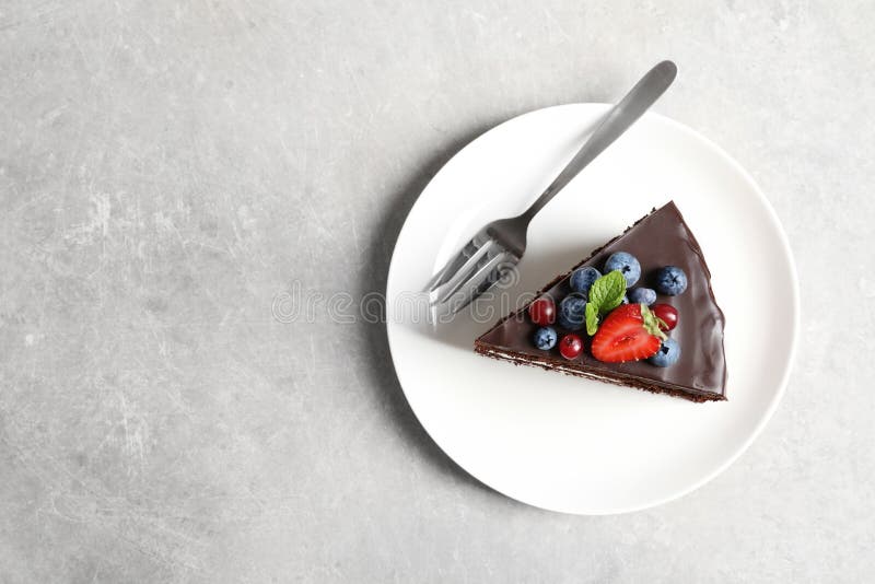 Plate with slice of chocolate sponge berry cake