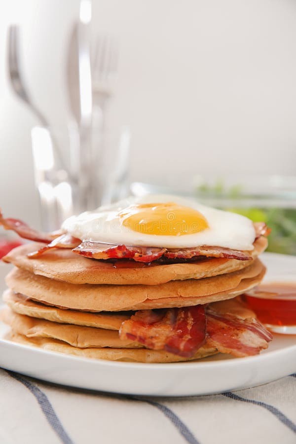Plate with Tasty Pancakes, Fried Egg and Bacon on Table Stock Image