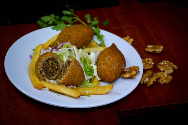 Plate of traditional eastern KIBBE MUQLIYEH Arabic traditional food . Middle Eastern meze platter.