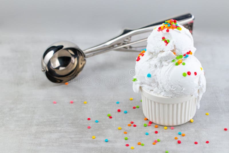 Plate of Vanilla Ice Cream Scoop Swith Sprinkles and Waffle Cones Stock