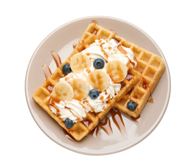 Plate with yummy waffles, whipped cream, blueberries and banana on white background