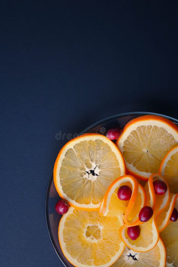 Plated cranberries and juicy orange slices stock image Plated cranberries and juicy orange slices stock image