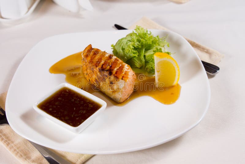 Plated Meal Of Grilled Fish With Garnishes Stock Image - Image of menu