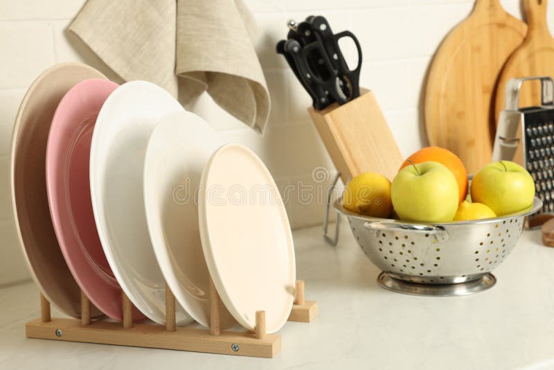 Plates, Different Cooking Utensils and Fruits on Kitchen Counter Stock