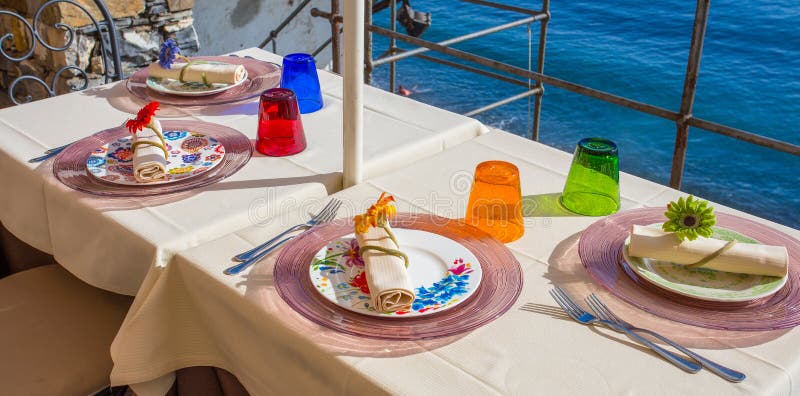 Plates, pods, cutlery and glasses of a restaurant table