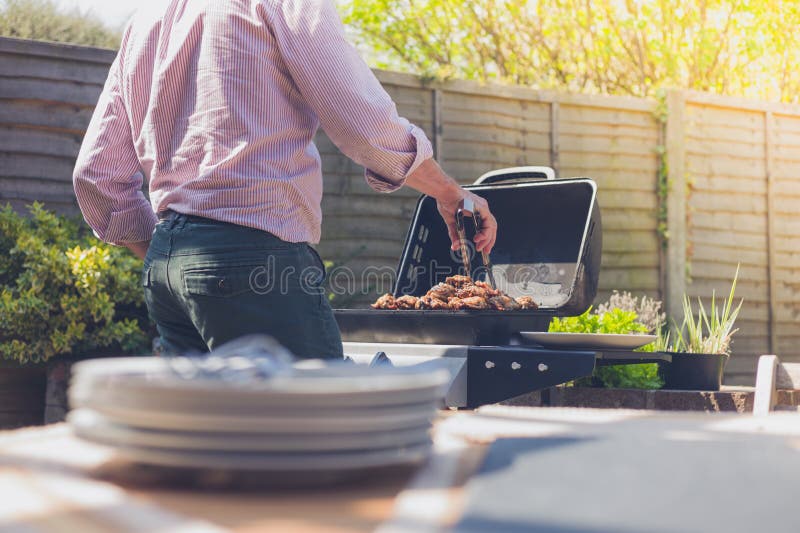Plates on a table outside with man in background royalty free stock photo Plates on a table outside with man in background royalty free stock photo