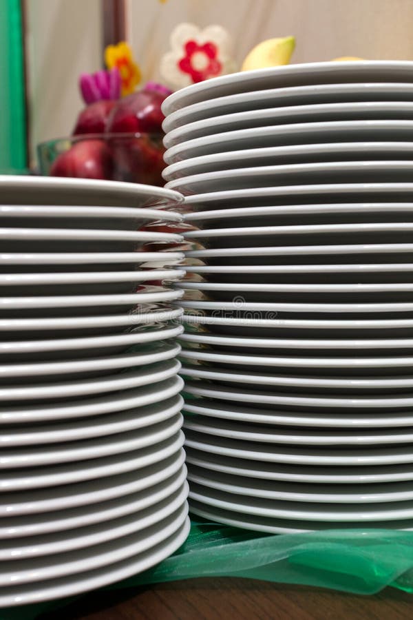 Stack Of Styrofoam Plates And Ceramic Plate On Table High-Res