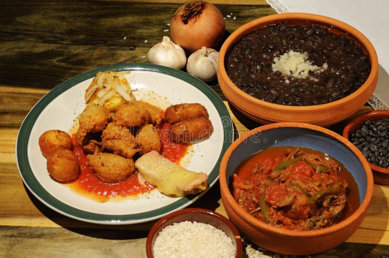 Assorted typical cuban dishes over wooded table. Assorted typical cuban dishes over wooded table