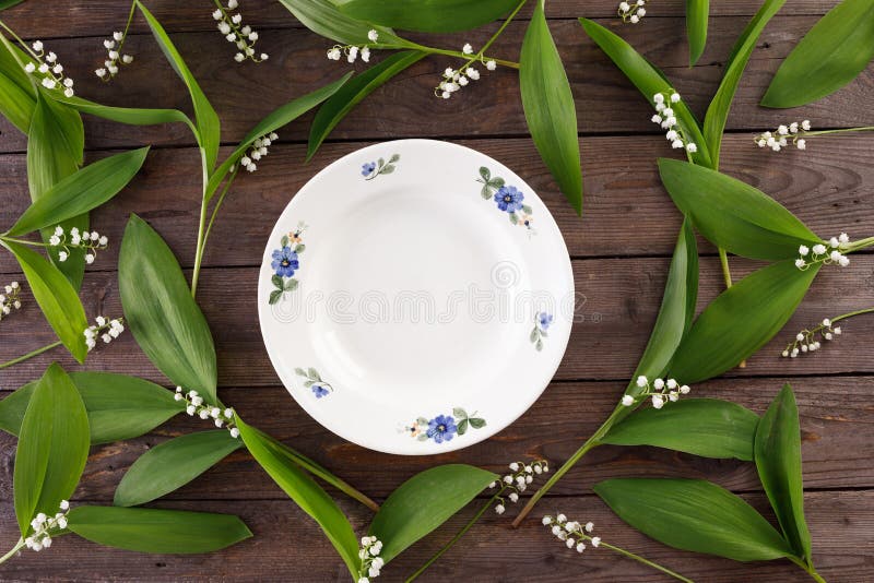 Platte und Dekor von Maiglöckchenblumen auf dem Hintergrund von hölzernen Brettern der Weinlese Weinlesehintergrund mit Blumen un lizenzfreies stockbild Platte und Dekor von Maiglöckchenblumen auf dem Hintergrund von hölzernen Brettern der Weinlese Weinlesehintergrund mit Blumen un lizenzfreies stockbild