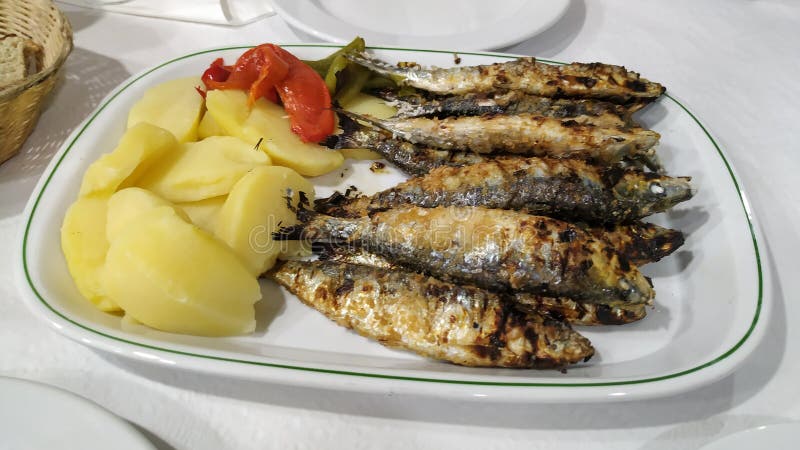 Platter of fresh grilled sardines with potatoes and peppers. Typical dish in Portugal.