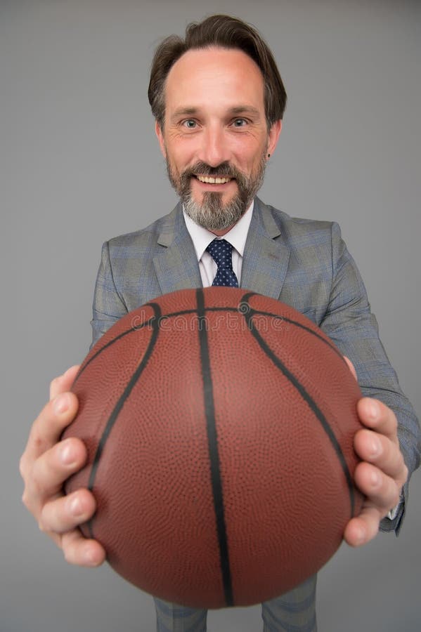 Play basketball be happy. Happy businessman hold basketball ball. Basketball coach grey background. Basketball coaching royalty free stock photos Play basketball be happy. Happy businessman hold basketball ball. Basketball coach grey background. Basketball coaching royalty free stock photos