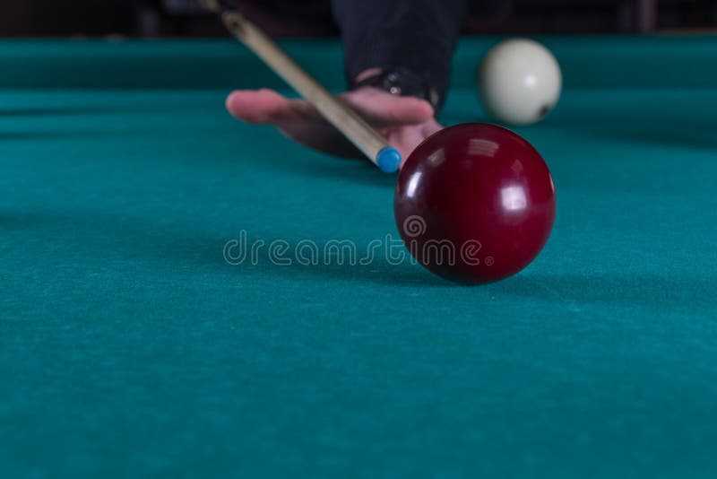 Play billiards. cue and billiard balls. hammer the ball into the hole