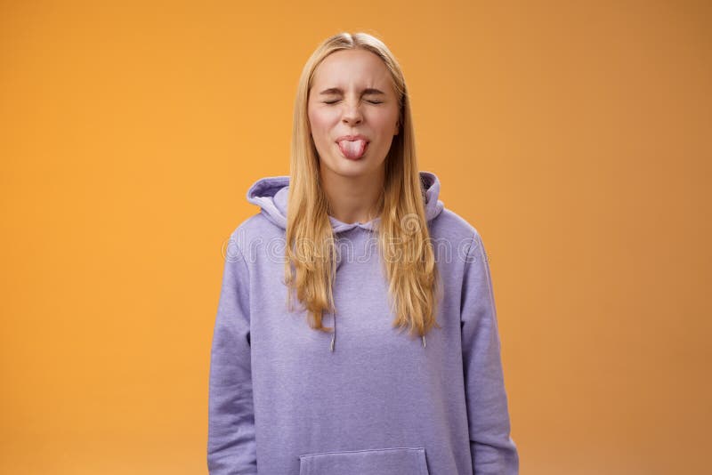 Playful Amused Charismatic Young Funny Blond Girl Having Fun Close Eyes Showing Tongue 