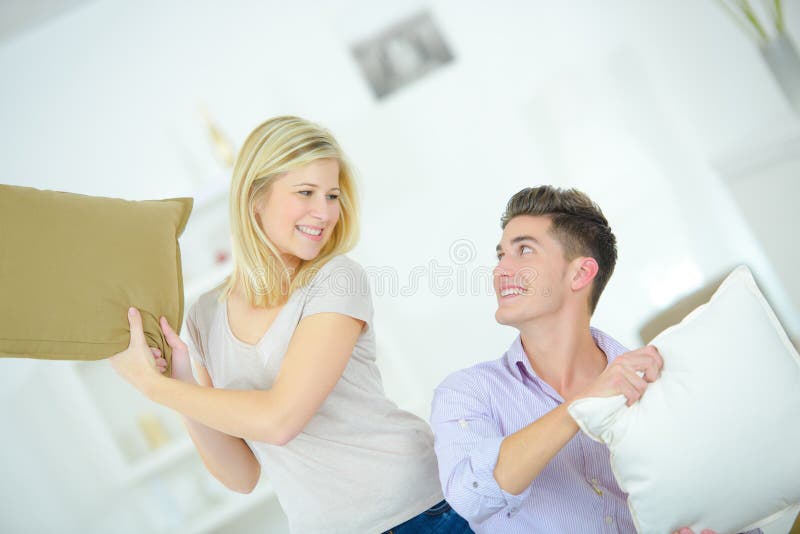 Playful Couple Having Pillow Fight Stock Photo Image of close