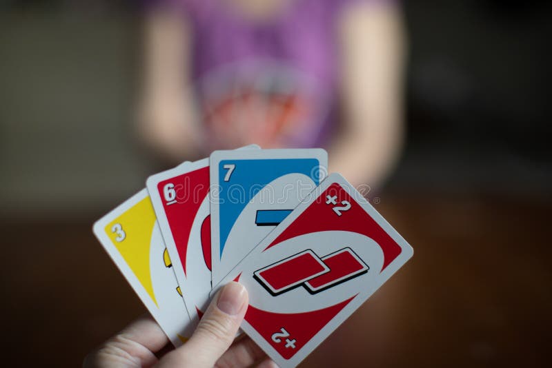 Deck of Uno Game Cards Scattered All Over on a Table. American