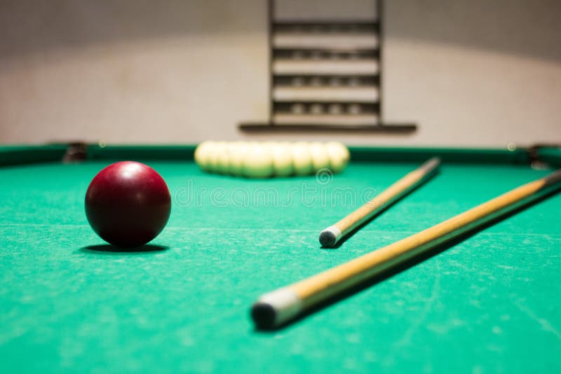 Playing Billiard. Billiards Balls and Cue on Green Billiards Tab Stock