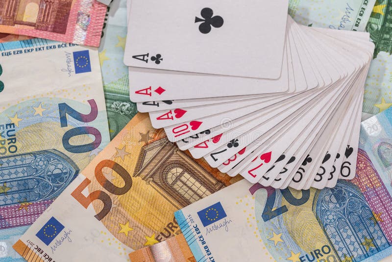 Playing cards on euro banknotes background, closeup