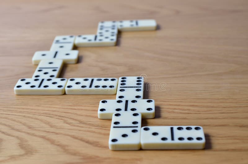Playing Dominoes on a Wooden Table. Dominoes Game Concept Stock Image