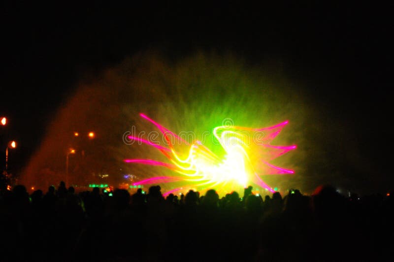 Playing fountains show with fireworks