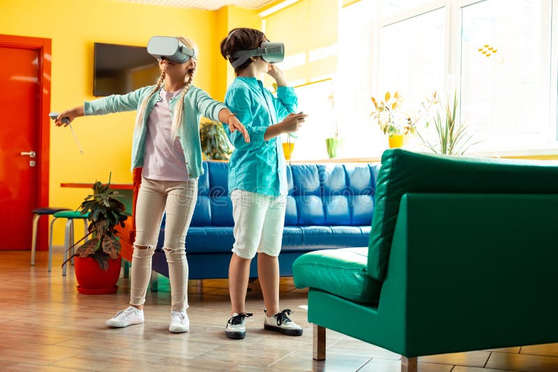 Two classmates walking together in virtual reality. stock photo