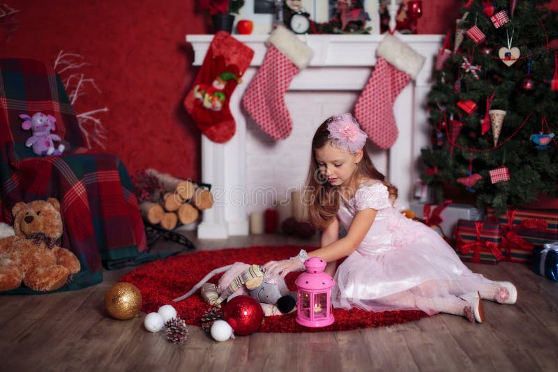 Playing girl near Christmas tree