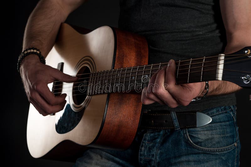 Playing Guitar. Acoustic Guitar in the Hands of the Guitarist