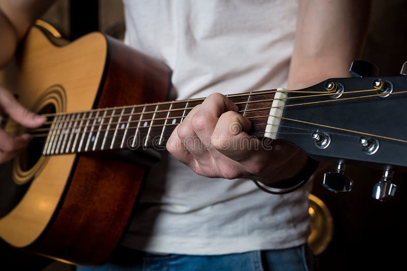 Playing Guitar. Acoustic Guitar in the Hands of the Guitarist
