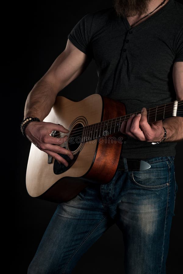 Playing Guitar. Acoustic Guitar in the Hands of the Guitarist