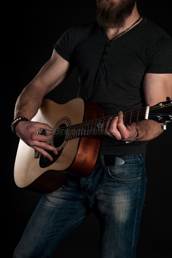 Playing Guitar. Acoustic Guitar in the Hands of the Guitarist