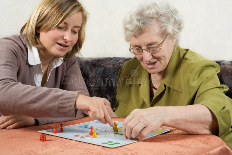 Grandmother and granddaughter playing ludo. Old granny stock images, royalty-free photos and pictures