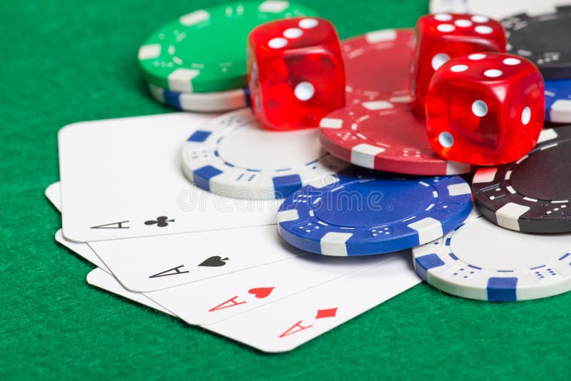 Playing poker chips, dice and cards on the green table