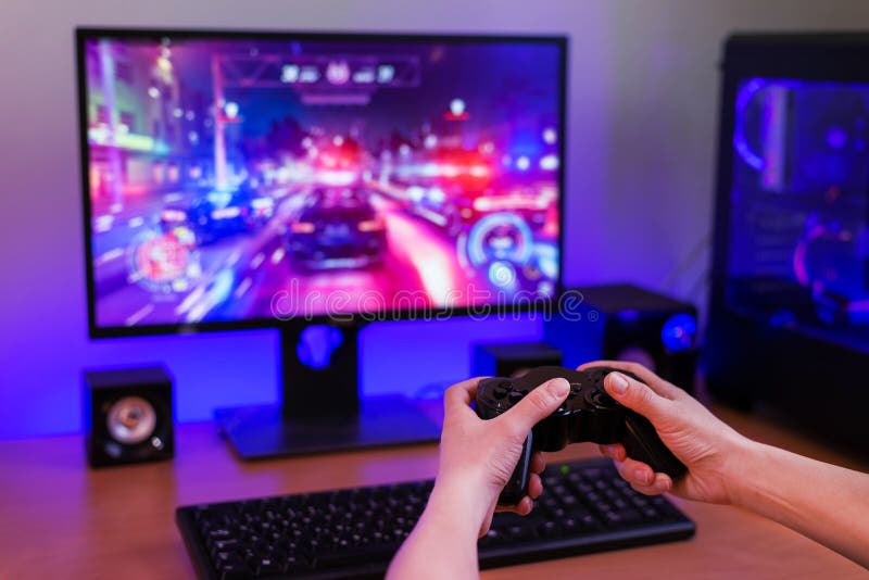 Playing racing games on computer concept. Hand holds the joystick royalty free stock photography