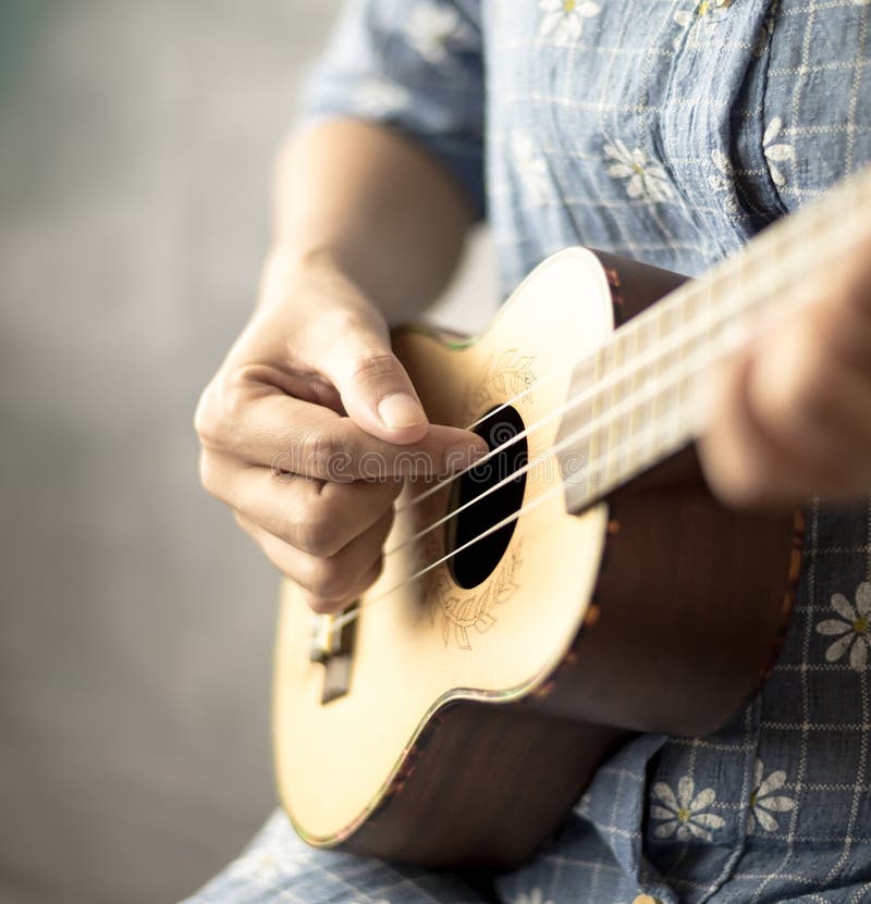 Playing ukulele stock image. Image of female, music, adult 98143427