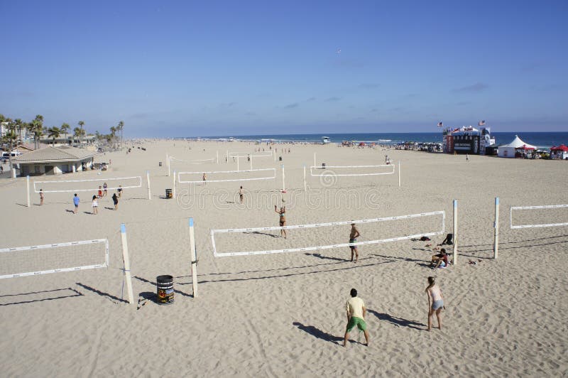 A group of people were playing Volley Ball at the Beach under the heat of the sun...