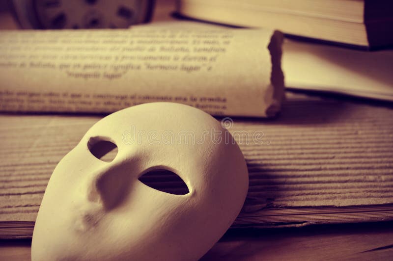 A pile of books and a mask, depicting the concept of playwriting and performing arts. A pile of books and a mask, depicting the concept of playwriting and performing arts