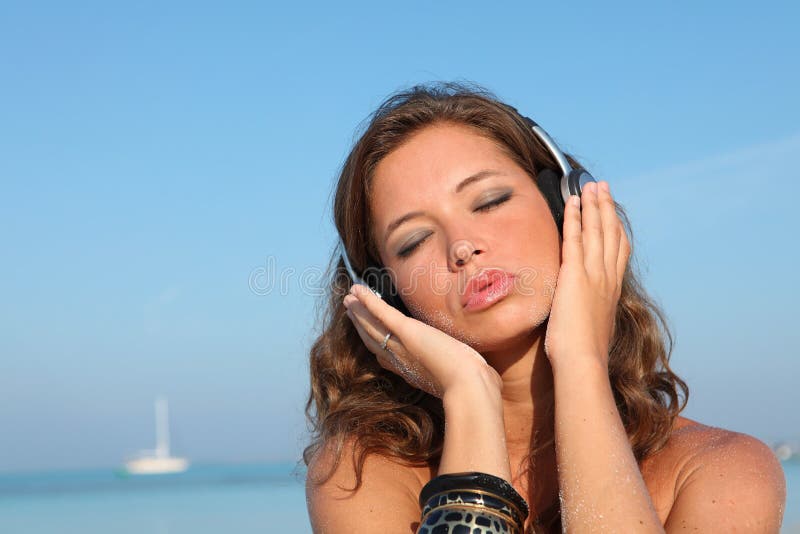 Woman with music and headphones on beach. Woman with music and headphones on beach