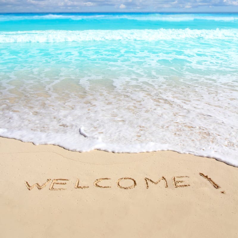 Greetings welcome beach spell written on sand Caribbean tropical sea. Greetings welcome beach spell written on sand Caribbean tropical sea