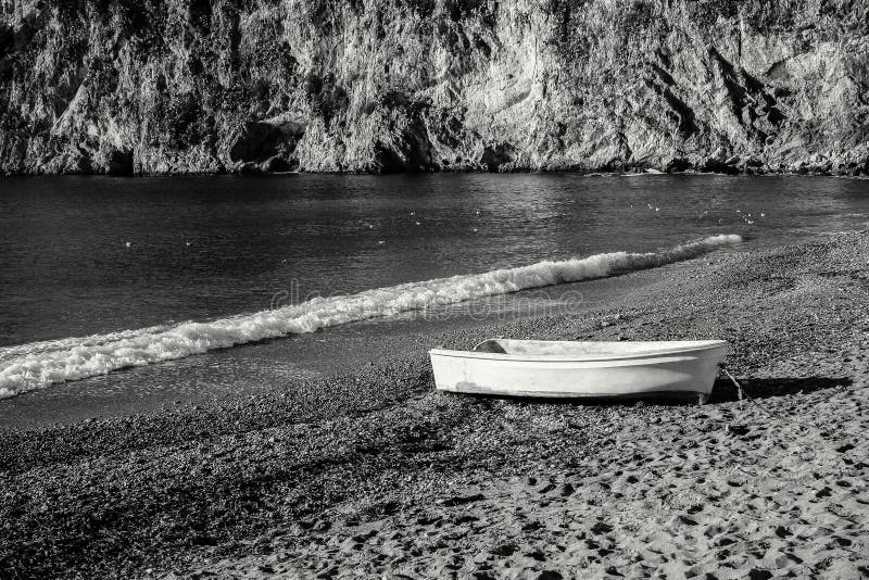 An Old White Boat On The Beach Plage Mala In Cap d'Ail In France. An Old White Boat On The Beach Plage Mala In Cap d'Ail In France