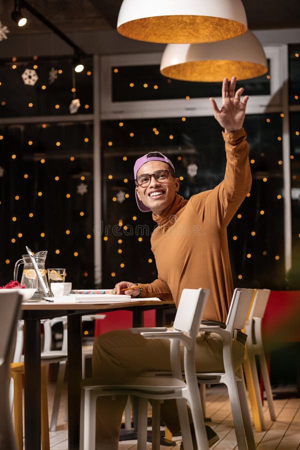 What a surprise. Pleasant guy drinking water and seeing a familiar girl at the next table and waving to her. What a surprise. Pleasant guy drinking water and seeing a familiar girl at the next table and waving to her.