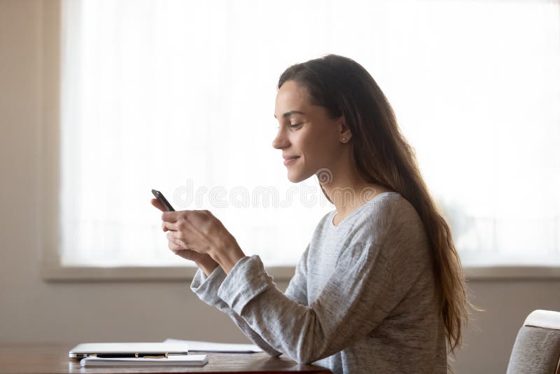 Pleasant mixed race woman chatting with friends in social networks.