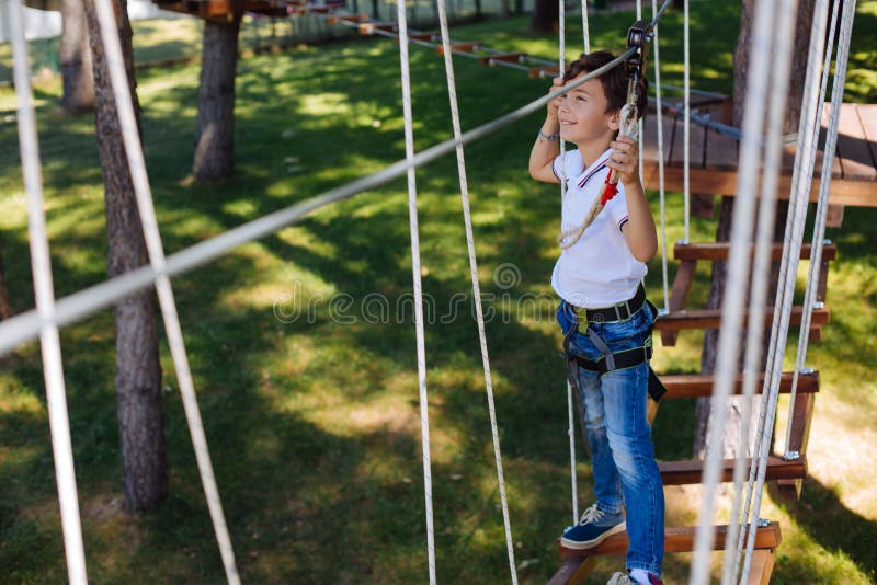 Pleasant preteen boy walking along trail at rope park royalty free stock photography Pleasant preteen boy walking along trail at rope park royalty free stock photography