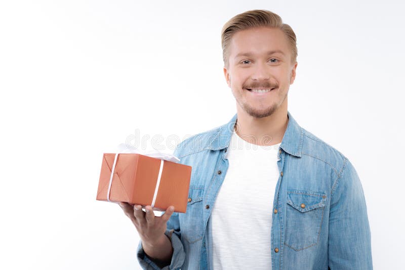 Pleasant Smiling Man Holding a Gift Box Stock Image - Image of ...